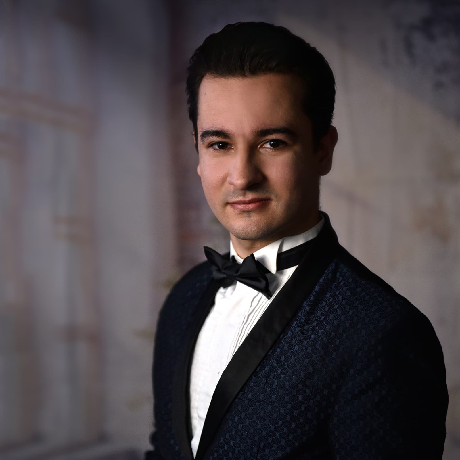 Portrait of Jakub Osmera in a navy patterned dinner jacket