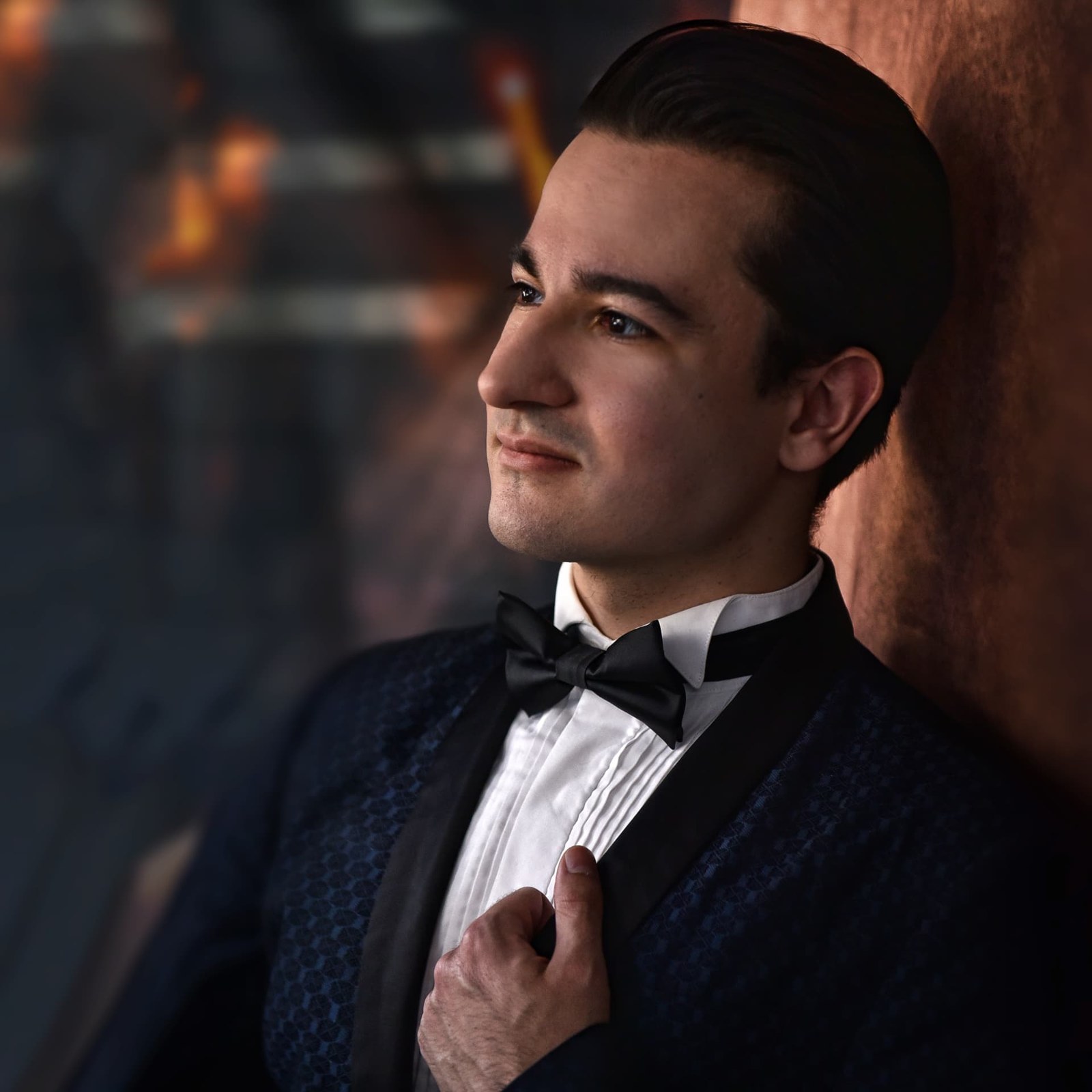 Jakub Osmera in profile, adjusting his jacket